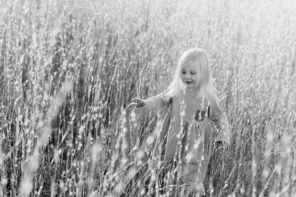 black and white little girl photo in field